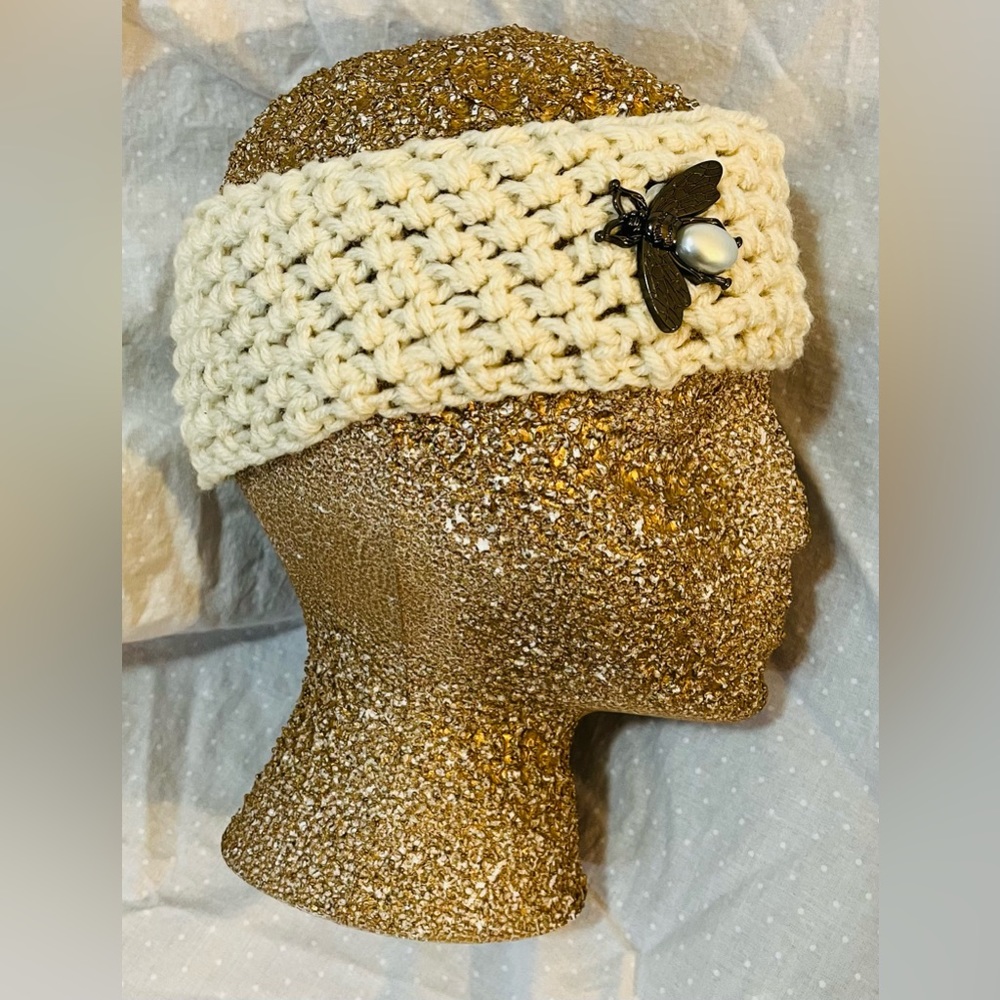 Beige hand crocheted headband ear warmer with decorative faux pearl bee button